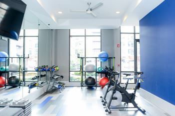 a gym with a lot of exercise equipment and a large window  at Avant & Avant II, Carmel, IN